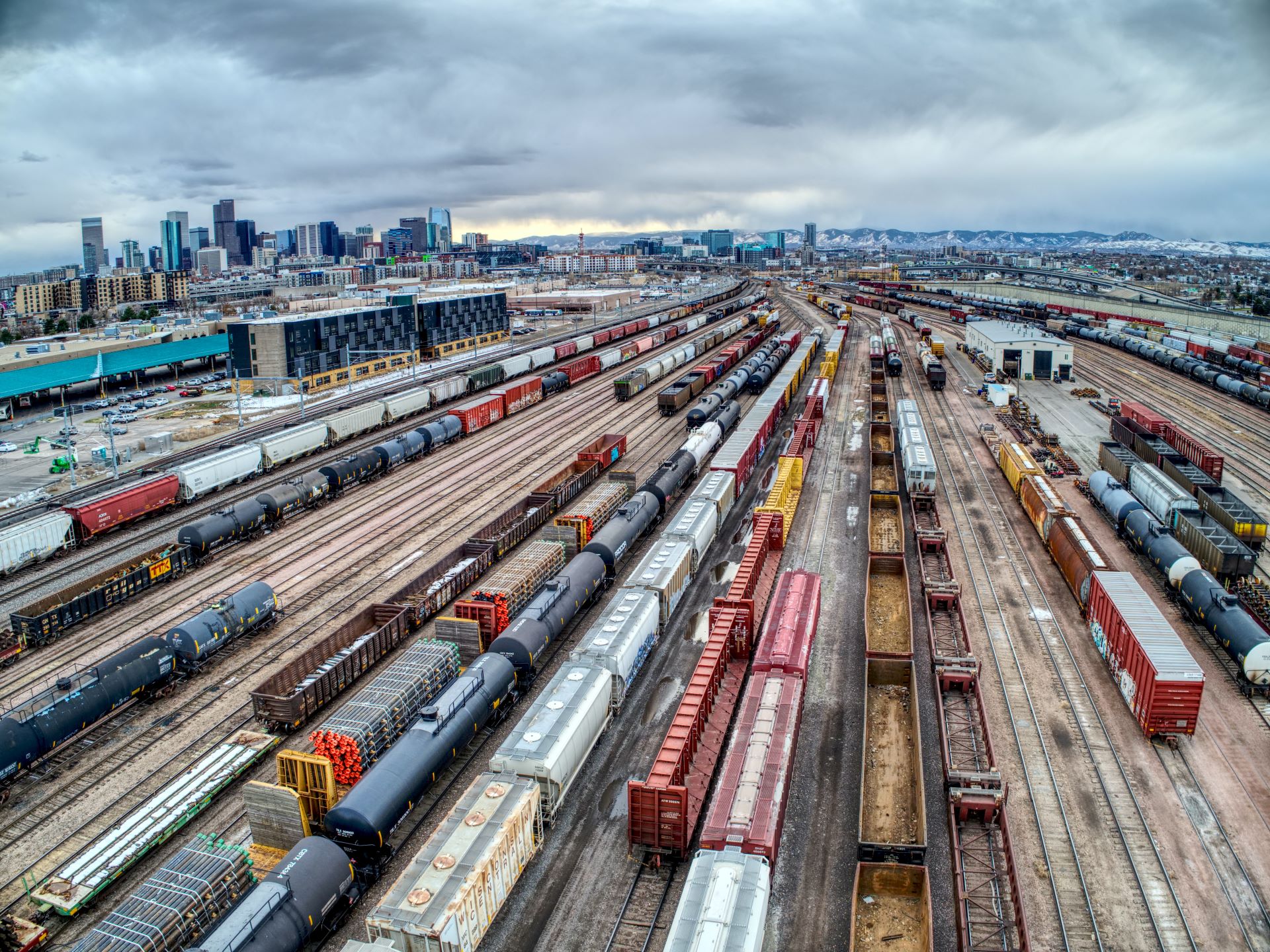 many colourful freight trains and carriages