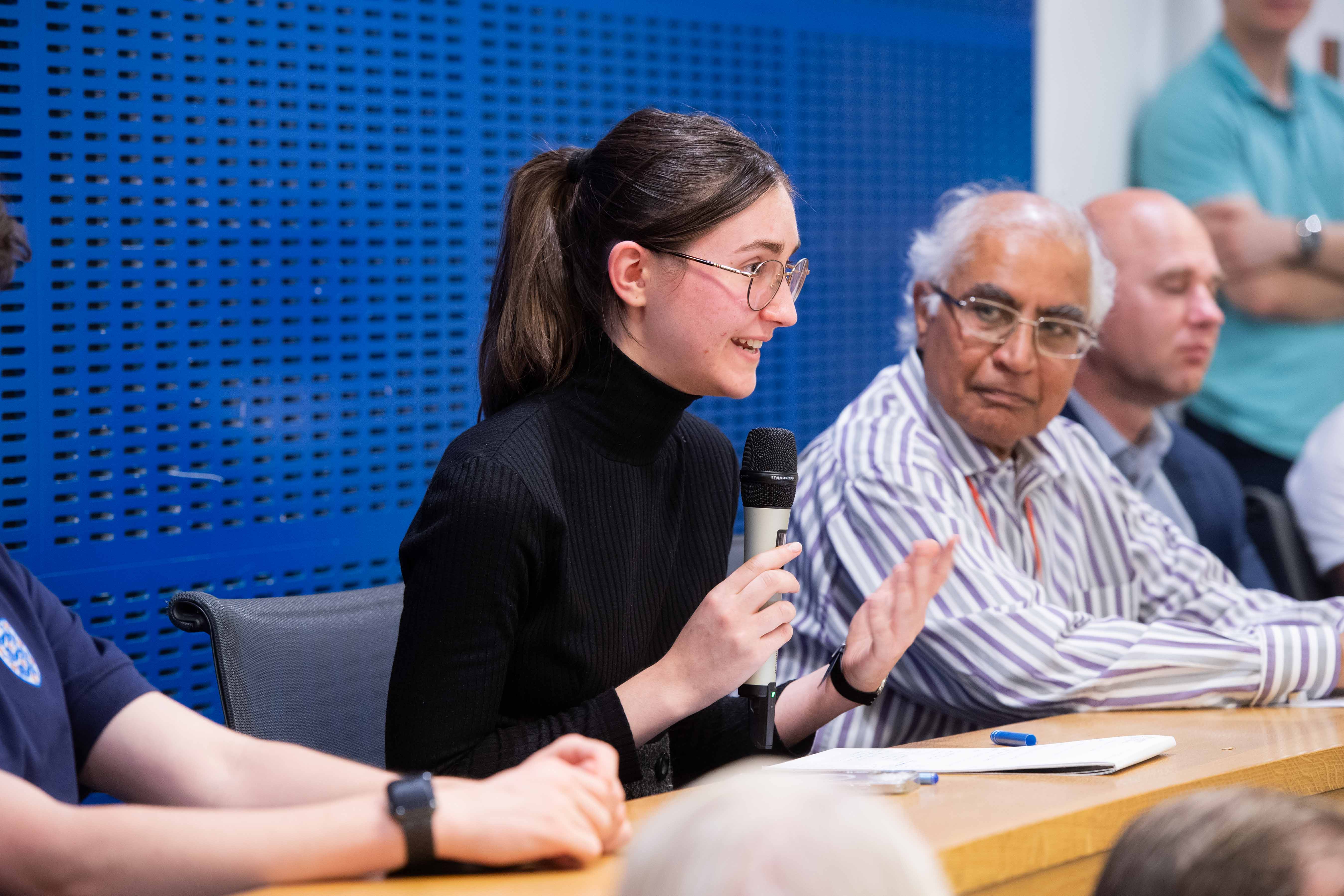 Woman asking audience question