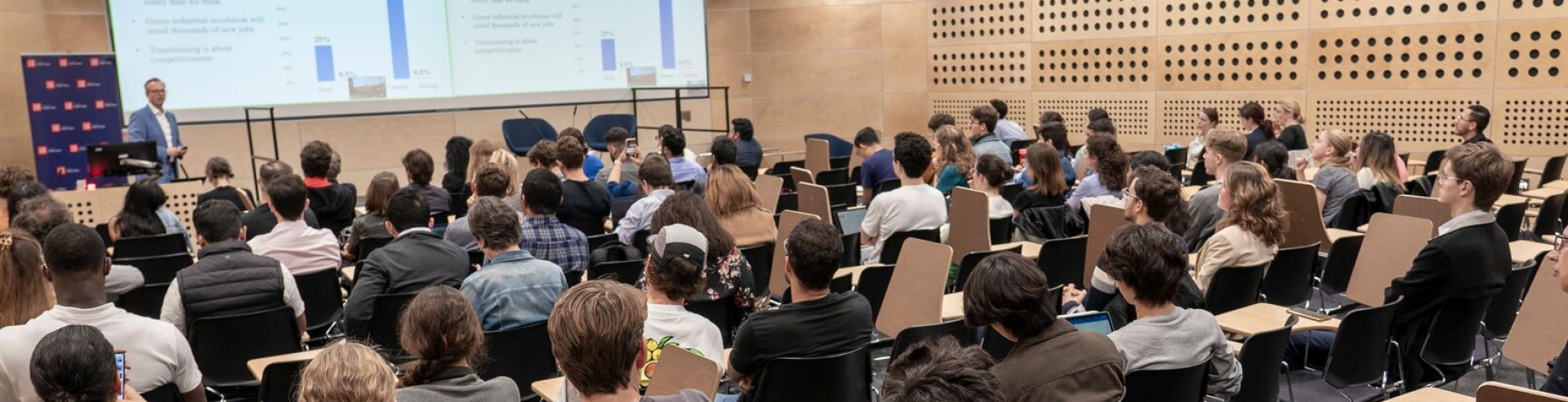 Conference room full of people, shown from the back of the room