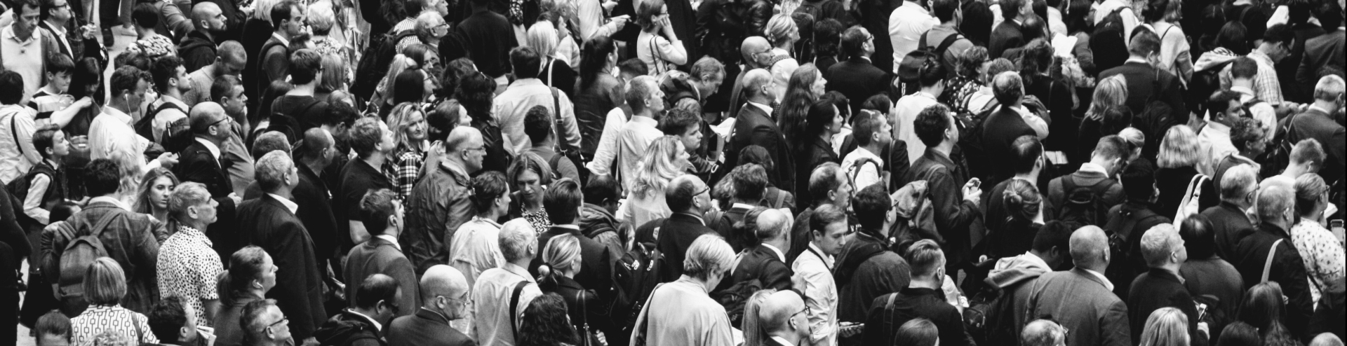 Black and white photo of a mass of people, faces unidentifiable