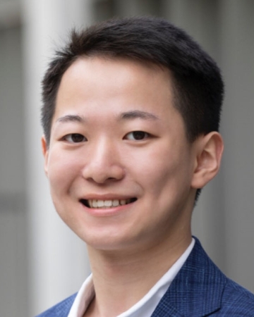 Portrait of Ronan Ding, FMG RA, Asian man, dark hair, wearing a navy jacket on top of a white shirt